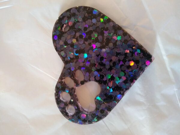 A heart shaped item with a paw print on it.