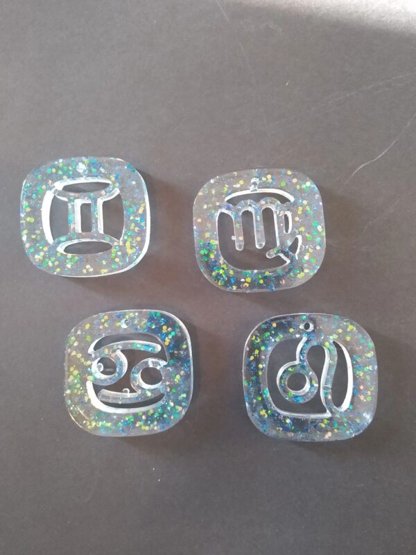 A set of four dice with the letters for each letter written on them.
