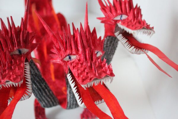 A close up of some red paper dragon heads