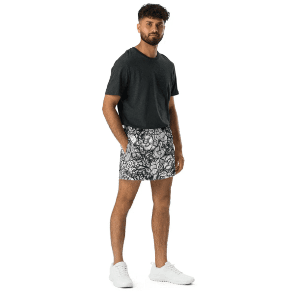 A man in black shirt and white shorts.