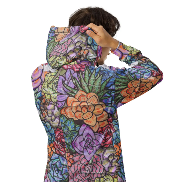 A person wearing a colorful hoodie with flowers on it.