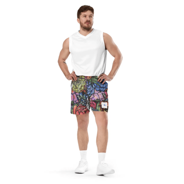 A man standing in front of the camera wearing shorts.