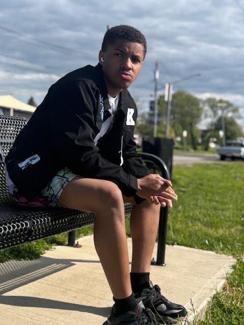 Person sitting on a bench outdoors.
